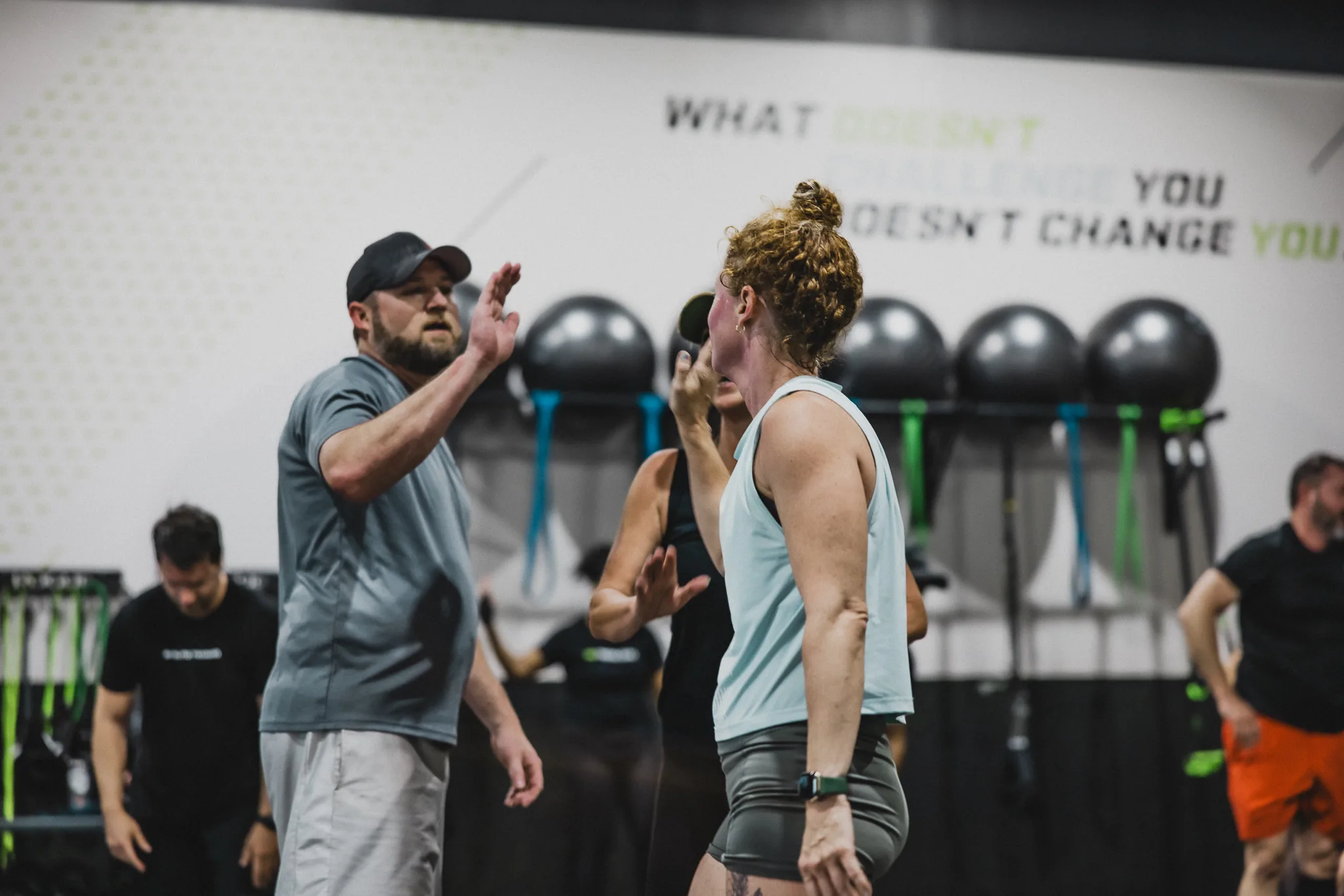 An ISI® coach and athlete sharing a high five on the training floor